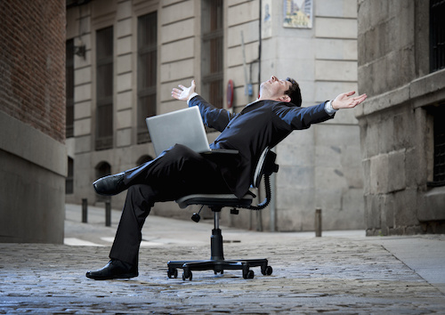 man in street on desk chair