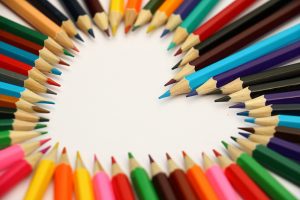 Multi-colored pencils arranged in the shape of a heart