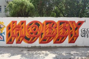 graffiti on a wall, displaying the word "hobby"