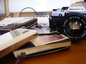 camera, notebook, phone on a table