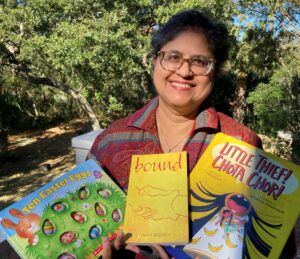 author holding copies of her books
