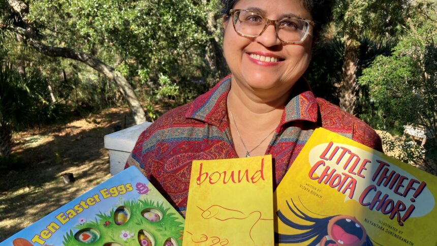 author holding copies of her books
