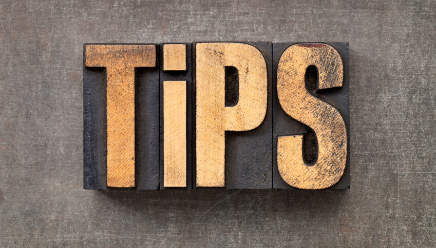 tips word - text in vintage letterpress wood type against a grunge metal sheet