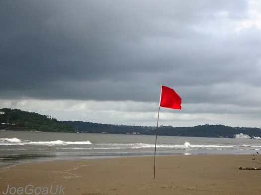 Header image: Red flag flying on beach