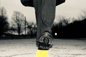 A person walks down the center of the road.