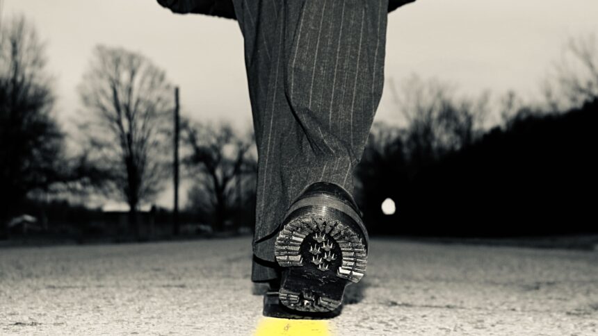 Photo by Hannah Van Houten. Used by permission. A person walks down the center of the road.