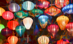 Bright, colorful Vietnamese wish lanterns hang from the ceiling.
