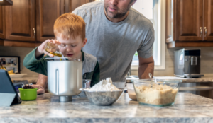Photo of boy measuring ingredients for bread machine