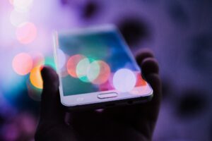 Person Holding Smart Phone by Rodion Kutsaiev