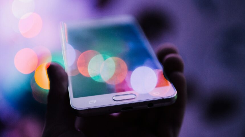 Person Holding Smart Phone by Rodion Kutsaiev