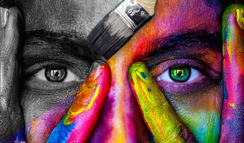 woman with a rainbow of color painted over half of her face