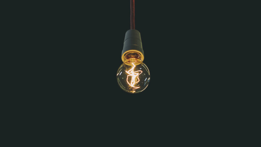 illuminated lightbulb on black background